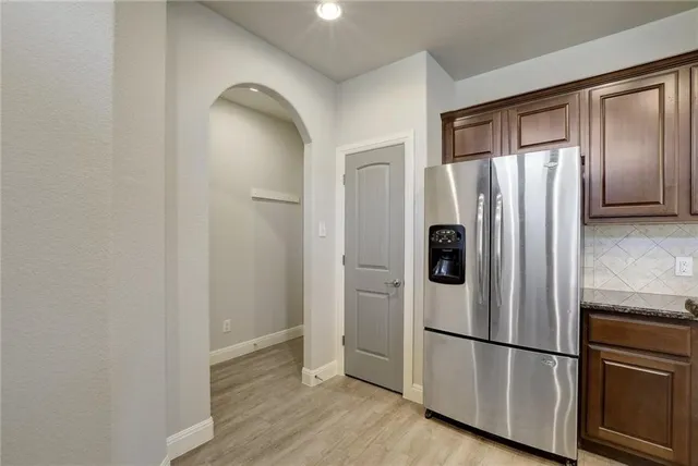 a view of a big room with wooden floor and windows