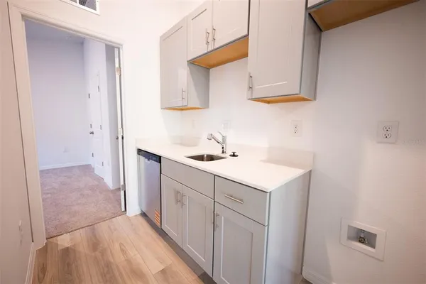 a view of kitchen with granite countertop stainless steel appliances refrigerator sink and cabinets