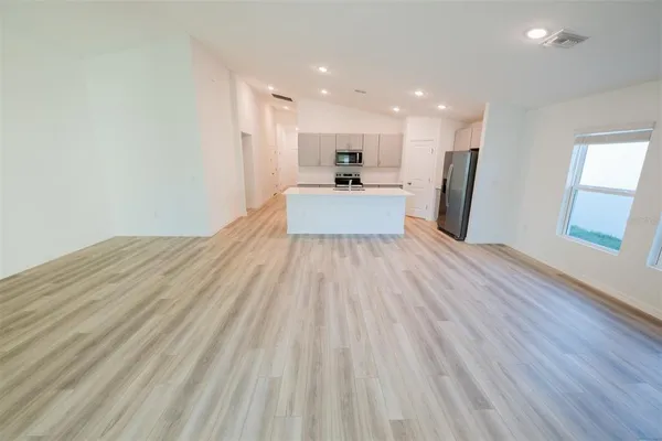 a kitchen with stainless steel appliances a microwave a sink and refrigerator