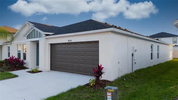 a kitchen with stainless steel appliances a sink a stove a refrigerator cabinets and living room view