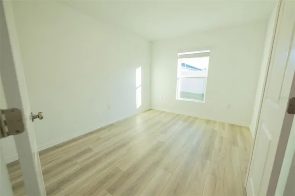 a kitchen with a sink and wooden floor