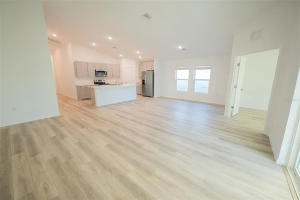 a kitchen with white cabinets stainless steel appliances and sink