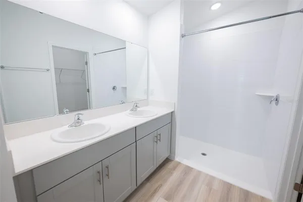 a kitchen with white cabinets a sink and dishwasher