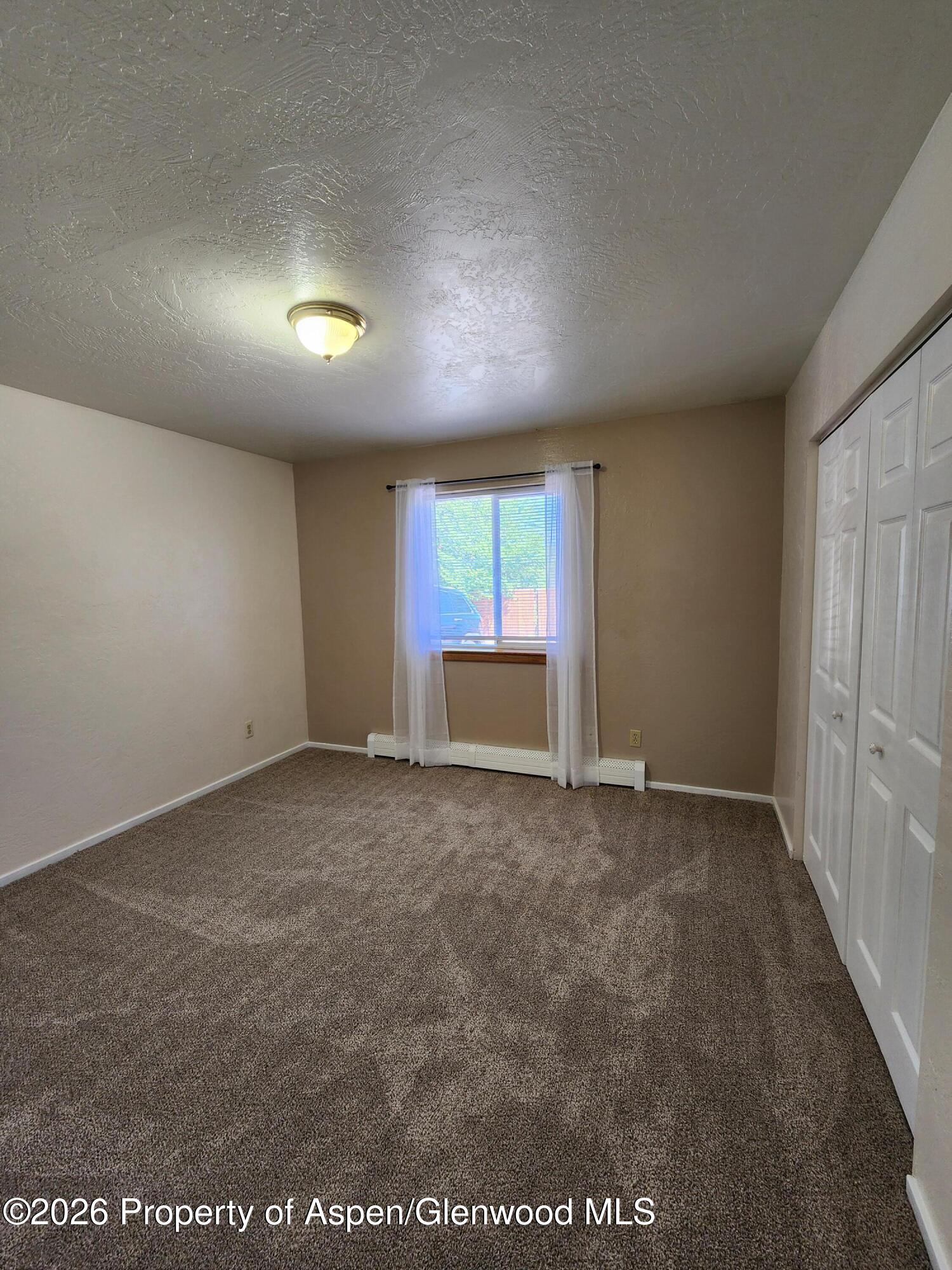 883 Taugenbaugh Boulevard Rifle, CO 81650 - Photo 14 of 18 an empty room with a window