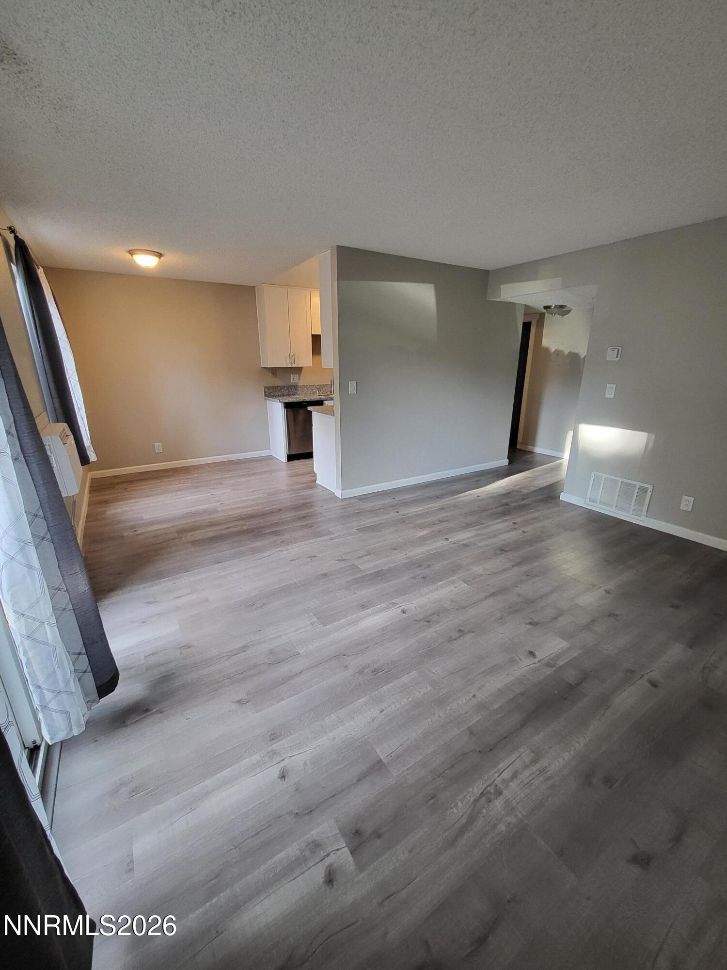 4606 Neil Road, Unit 197 Reno, NV 89502 - Photo 12 of 26 a view of empty room with wooden floor