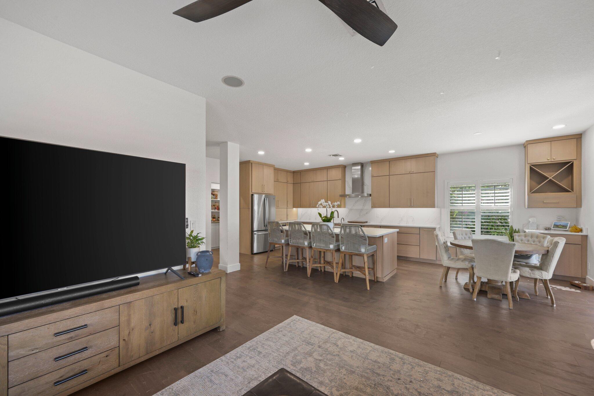 168 Andros Harbour Place Jupiter, FL 33458 - Photo 13 of 71 a living room with furniture a flat screen tv and floor to ceiling window