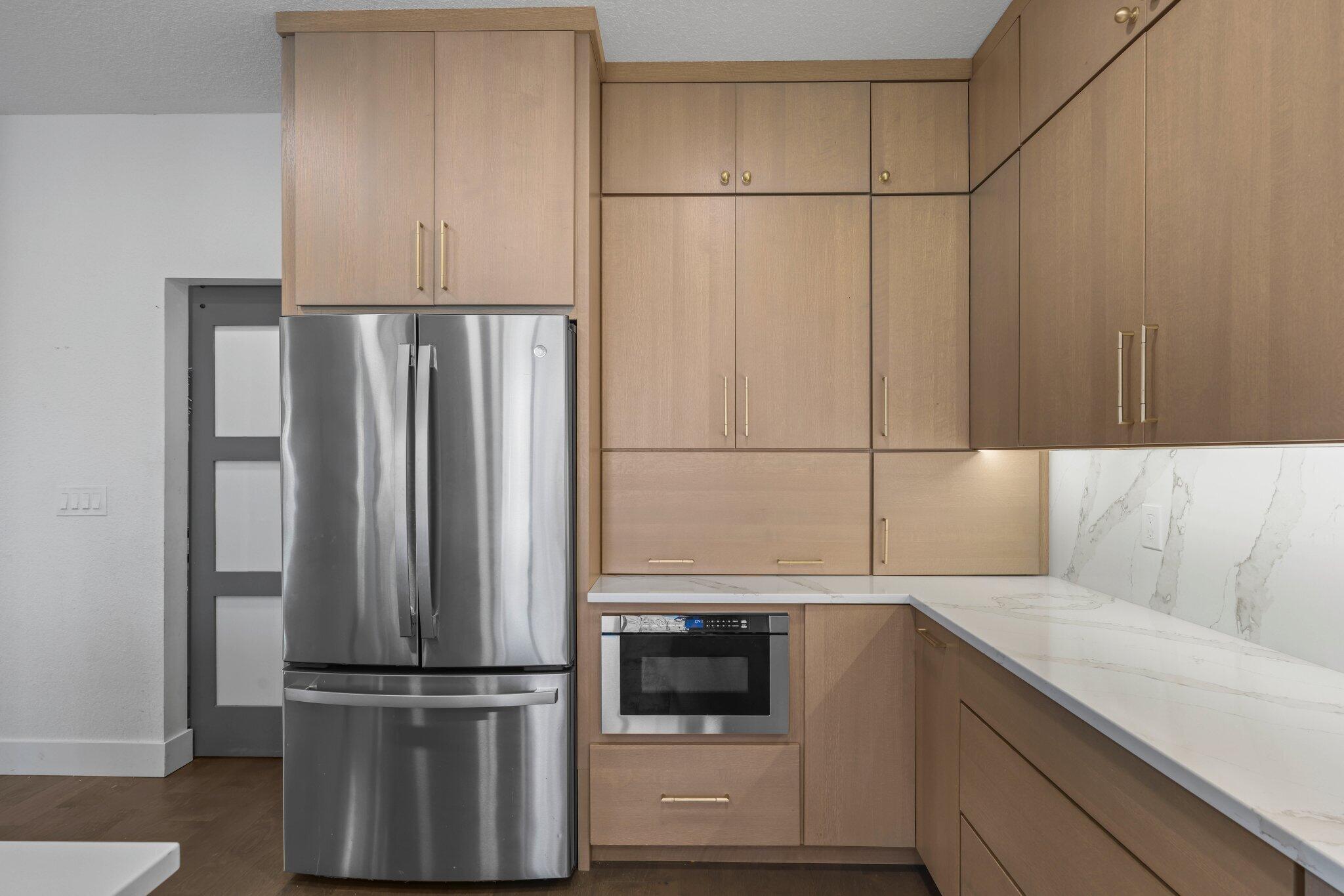 168 Andros Harbour Place Jupiter, FL 33458 - Photo 24 of 71 a kitchen with a refrigerator and white cabinets