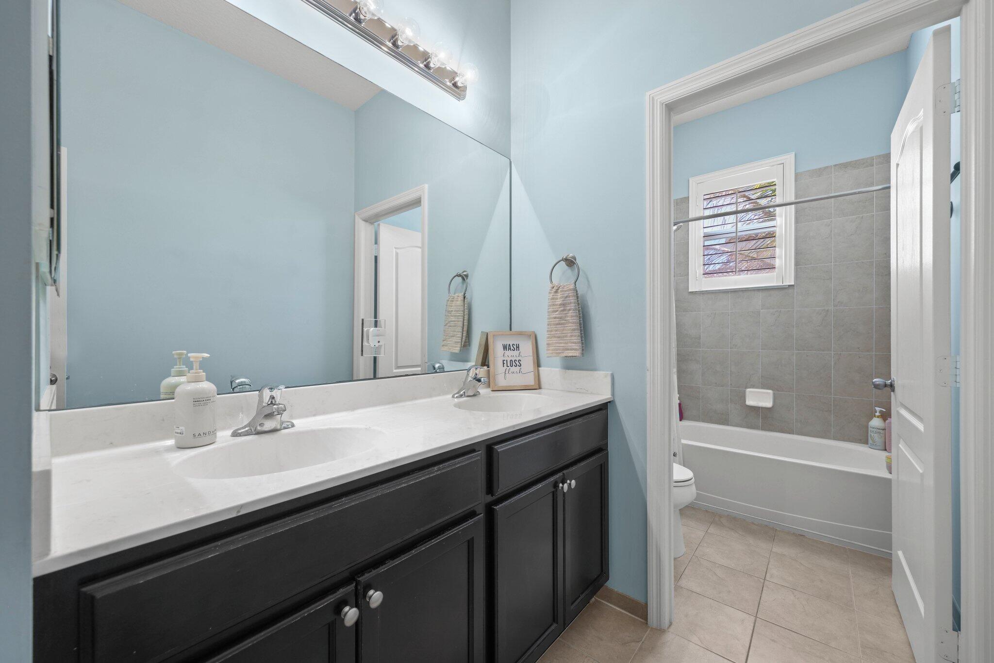 168 Andros Harbour Place Jupiter, FL 33458 - Photo 34 of 71 a bathroom with a sink a toilet and shower