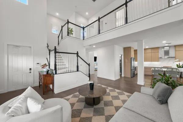 a living room with furniture and a chandelier