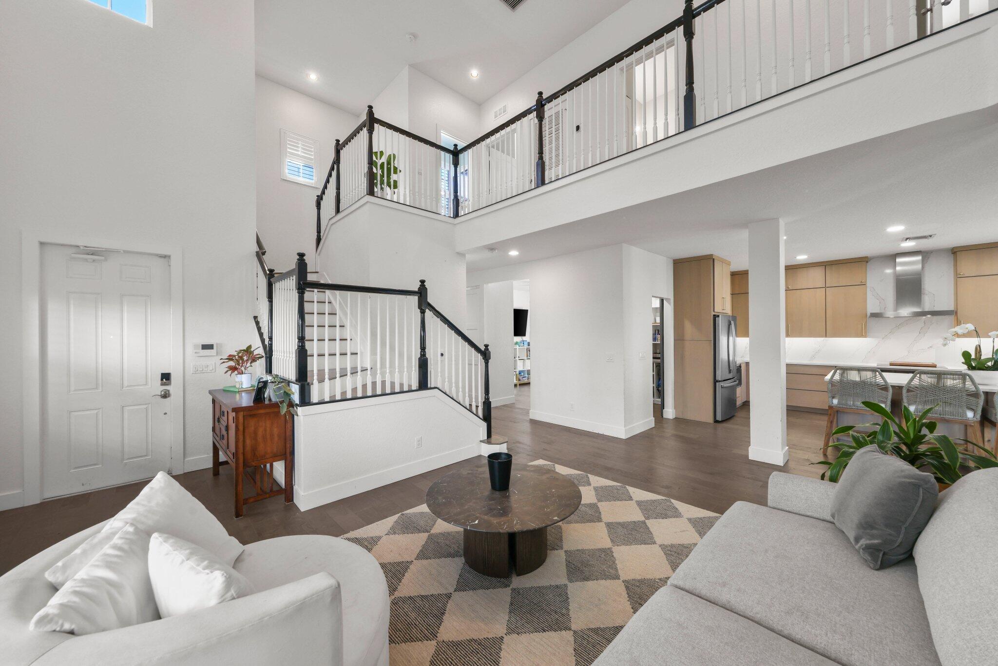 168 Andros Harbour Place Jupiter, FL 33458 - Photo 4 of 71 a living room with furniture and a chandelier