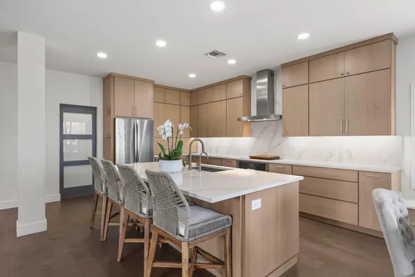 a kitchen with a refrigerator and a stove top oven