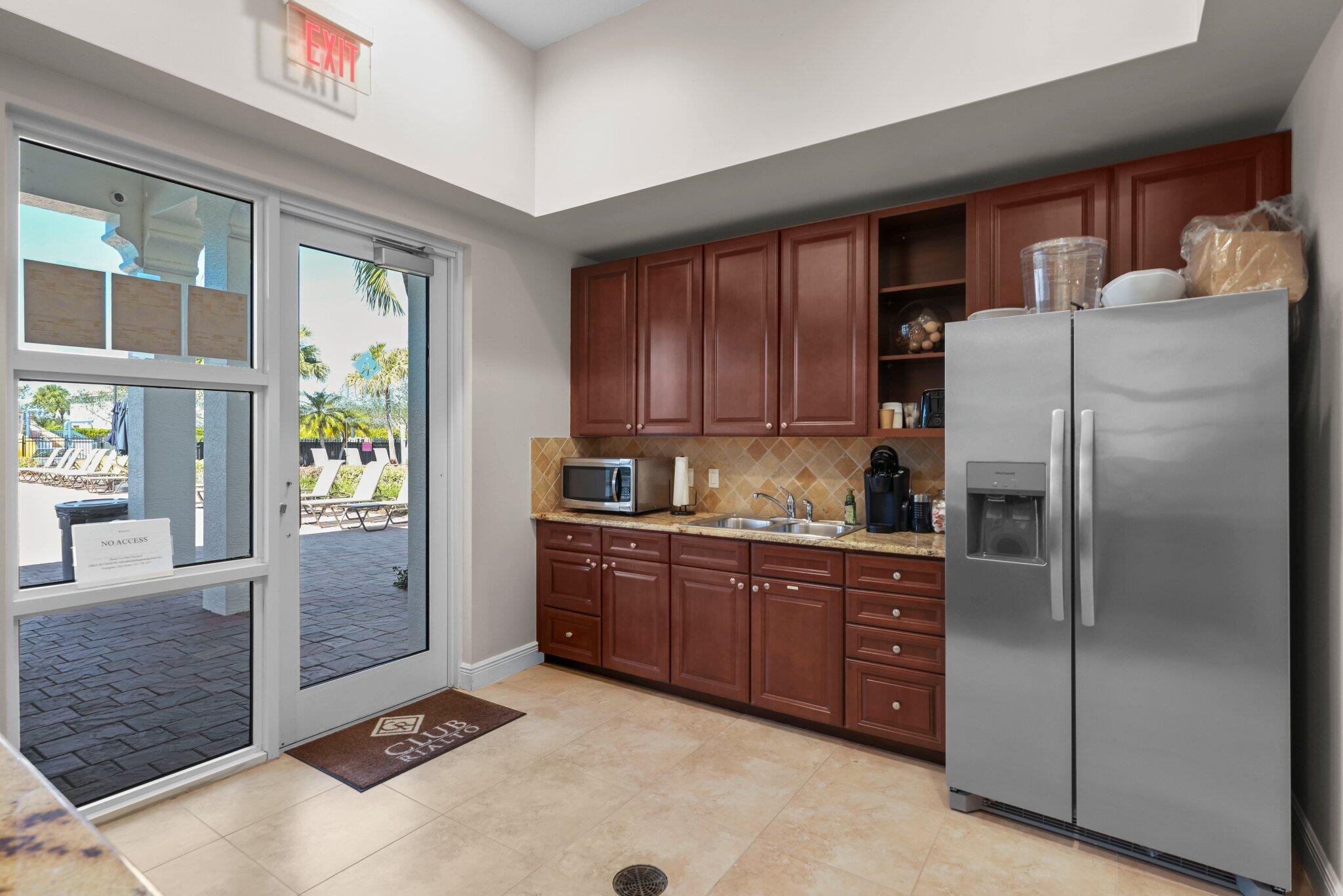 168 Andros Harbour Place Jupiter, FL 33458 - Photo 61 of 71 a kitchen with stainless steel appliances granite countertop a refrigerator and a stove top oven