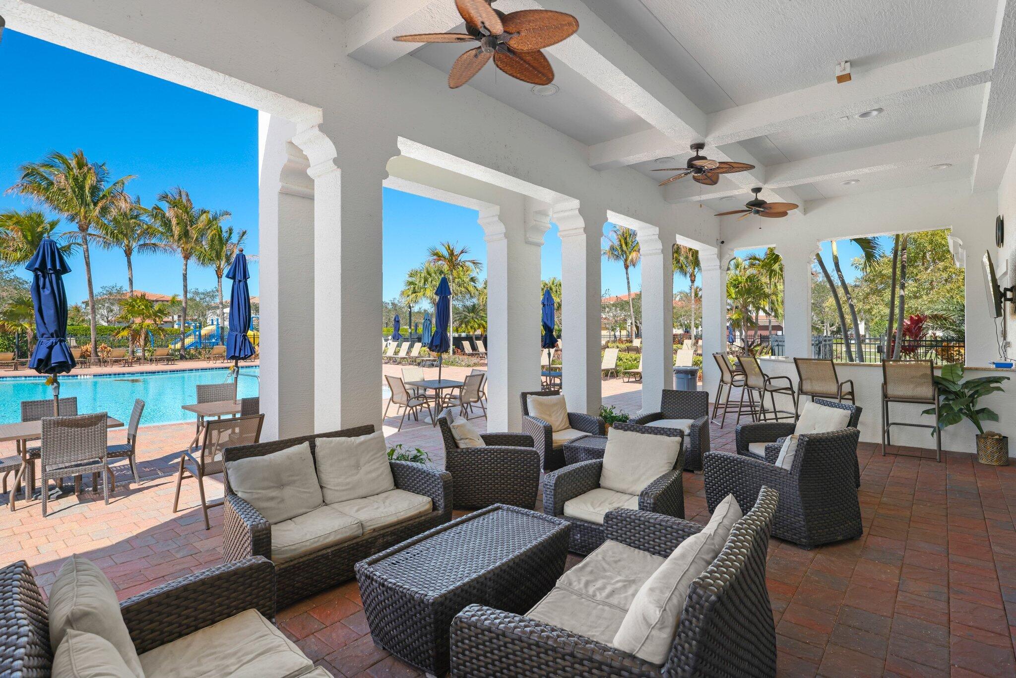 168 Andros Harbour Place Jupiter, FL 33458 - Photo 62 of 71 a living room with furniture ceiling fan and a large window