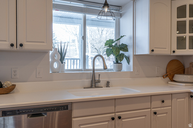 1045 Fox Farm Road Logan, UT 84321 - Photo 18 of 65 Kitchen with white cabinetry, dishwasher, light countertops, and glass insert cabinets