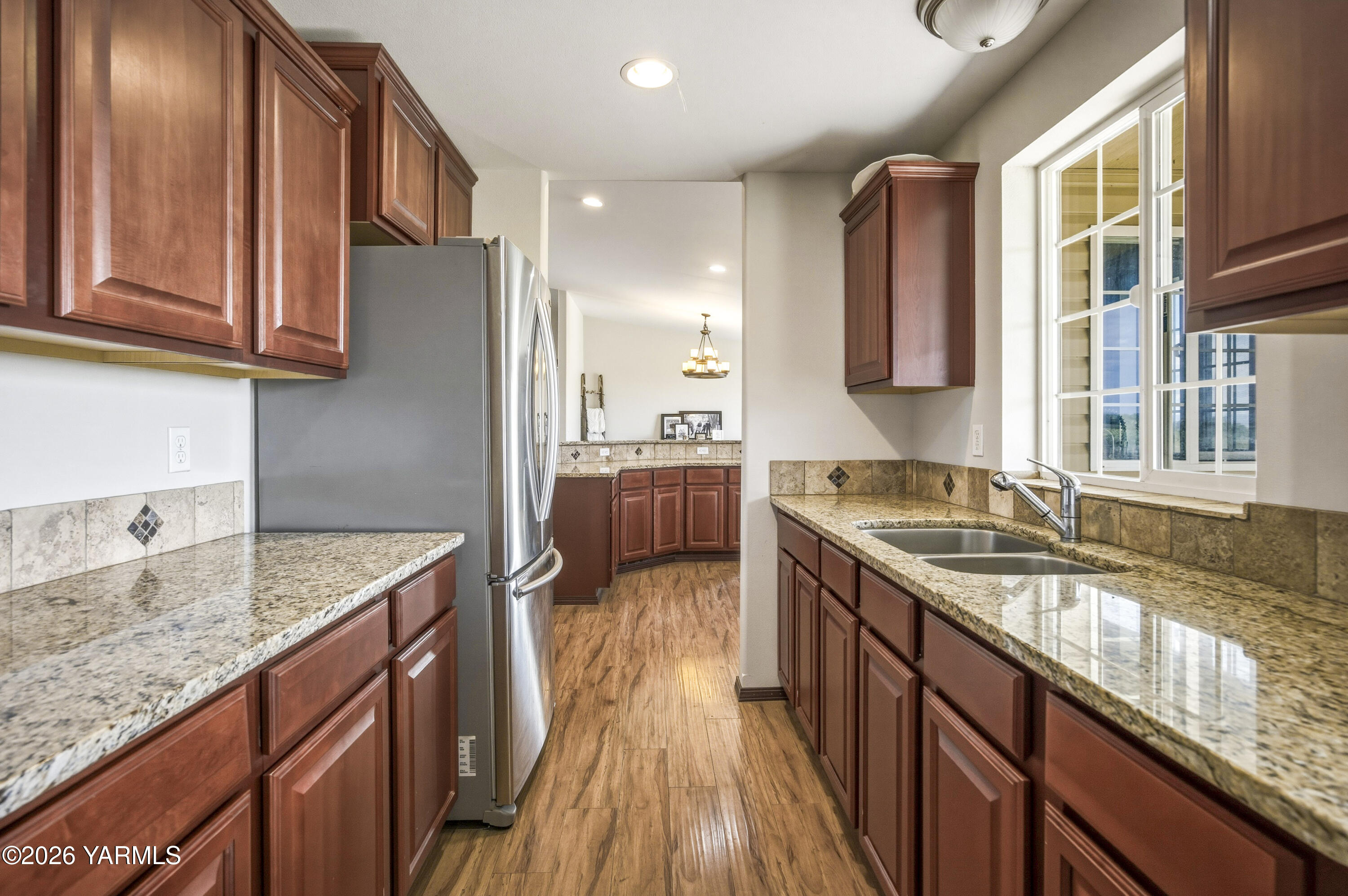2050 Olmstead Road Grandview, WA 98930 - Photo 34 of 60 a kitchen with a sink stove and cabinets