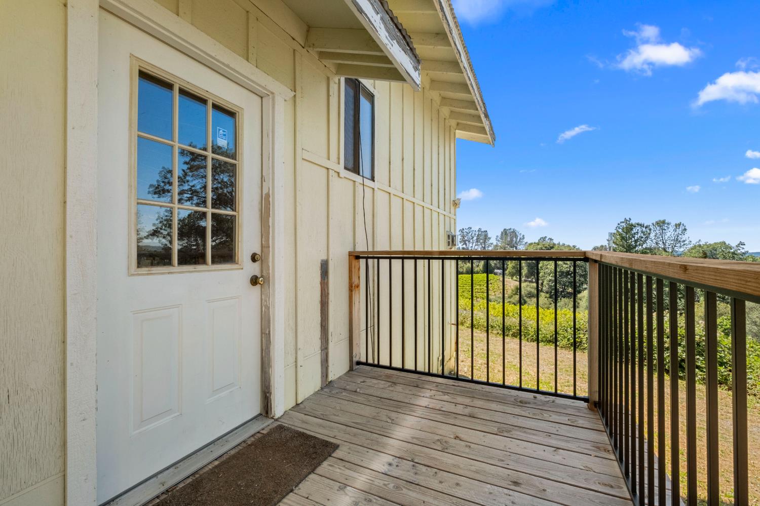 8221 Stoney Creek Road Somerset, CA 95684 - Photo 37 of 44 a view of a balcony with wooden floor and fence