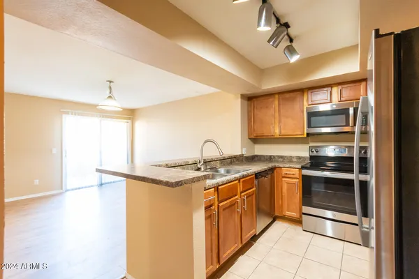 a kitchen with stainless steel appliances granite countertop a sink and a stove