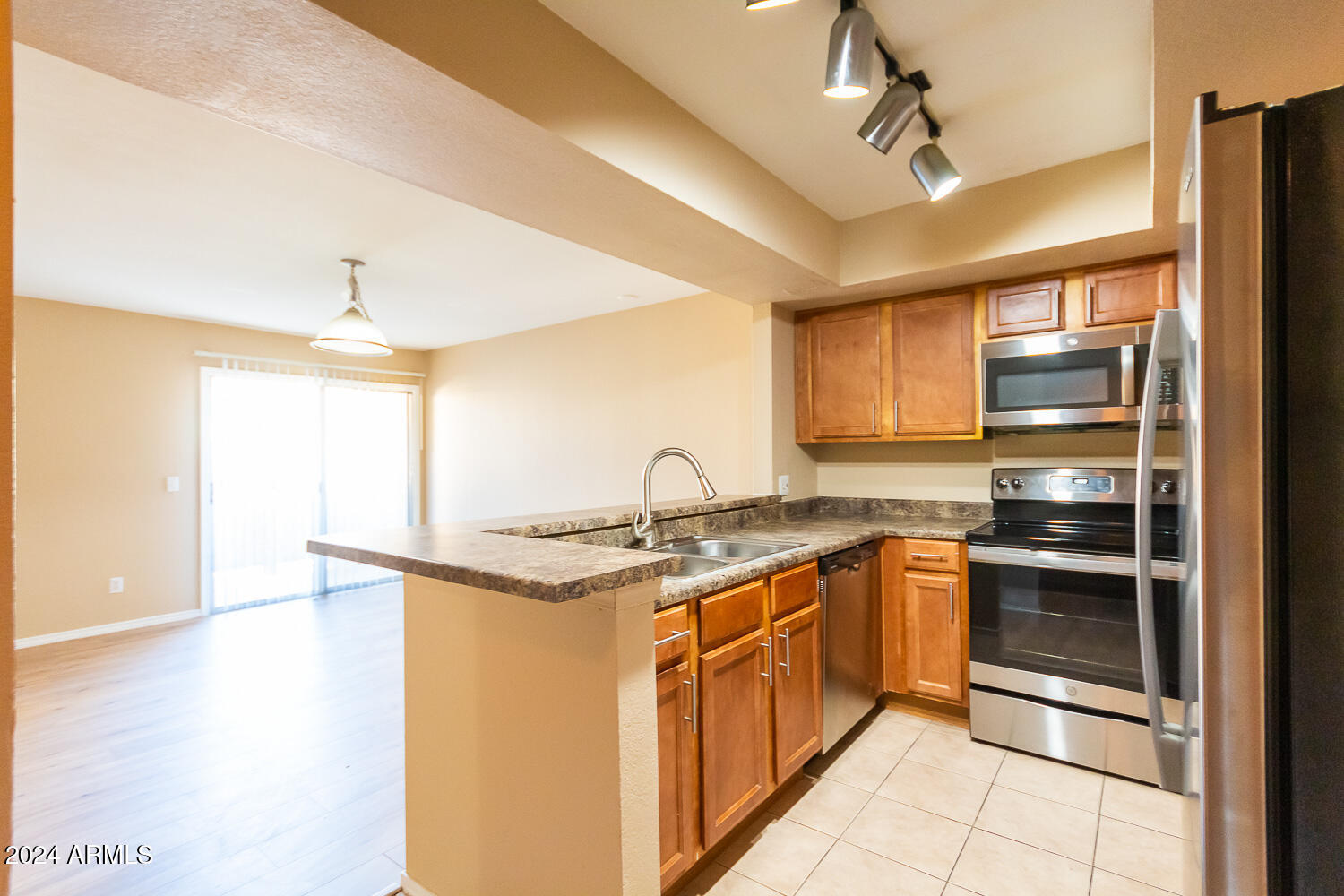 1331 West Baseline Road, Unit 253 Mesa, AZ 85202 - Photo 13 of 31 a kitchen with stainless steel appliances granite countertop a sink and a stove
