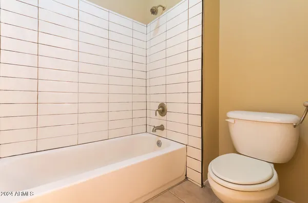 a bathroom with a toilet and bathtub