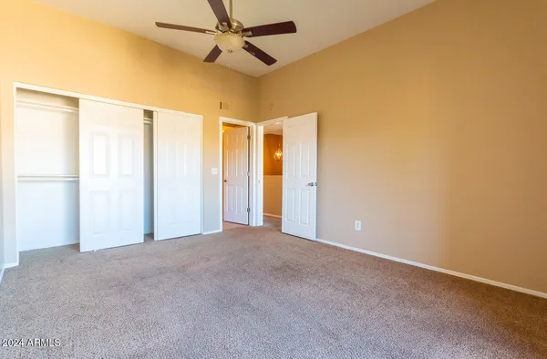 a view of a room with a ceiling fan and a window