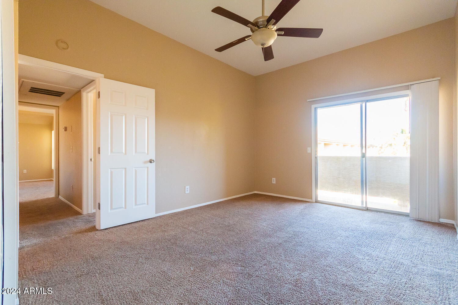 1331 West Baseline Road, Unit 253 Mesa, AZ 85202 - Photo 23 of 31 an empty room with a ceiling fan and a window