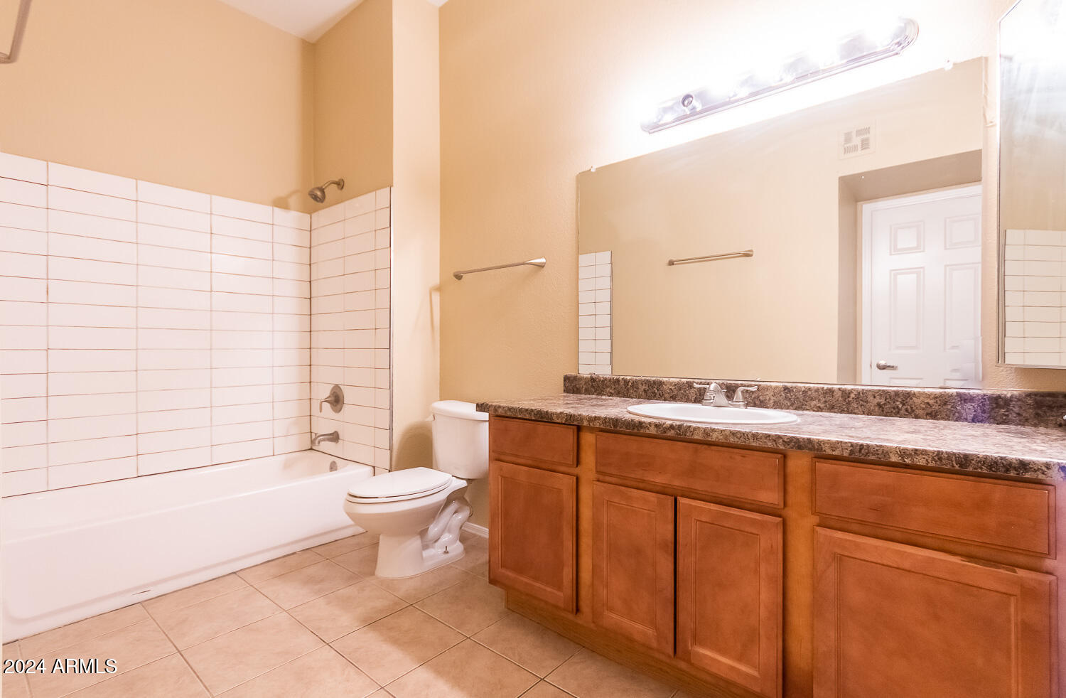 1331 West Baseline Road, Unit 253 Mesa, AZ 85202 - Photo 24 of 31 a bathroom with a granite countertop sink a toilet and mirror
