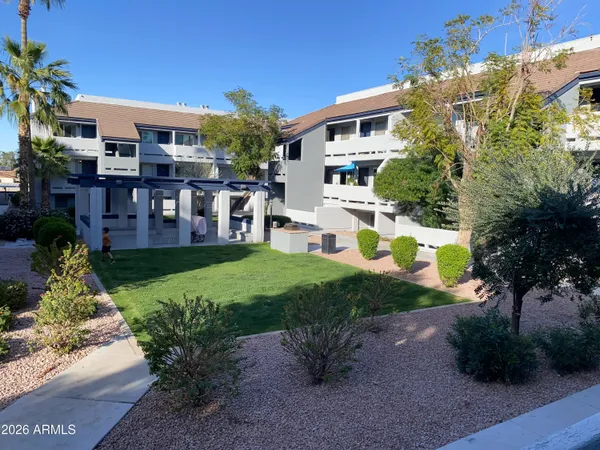 a view of a house with backyard and sitting area