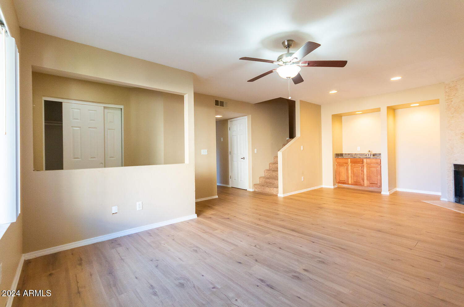 1331 West Baseline Road, Unit 253 Mesa, AZ 85202 - Photo 6 of 31 a view of an empty room with wooden floor and a ceiling fan