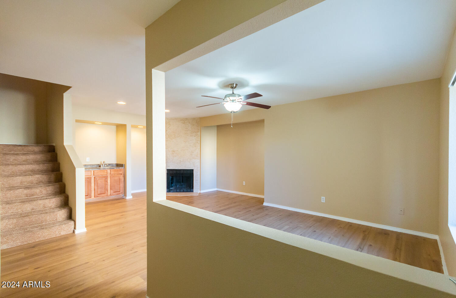 1331 West Baseline Road, Unit 253 Mesa, AZ 85202 - Photo 7 of 31 a view of a livingroom with a ceiling fan and wooden floor