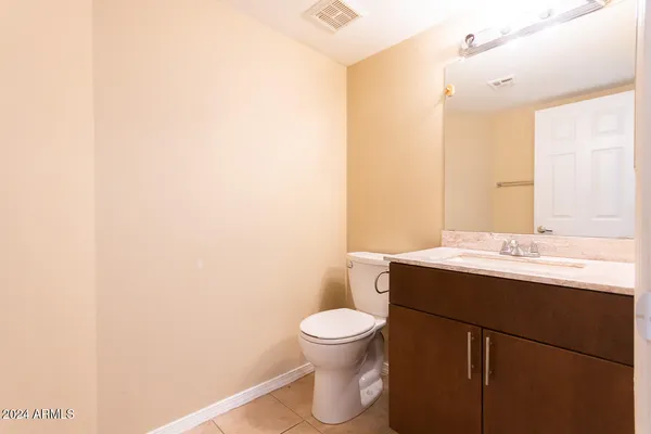 a bathroom with a sink a toilet and mirror