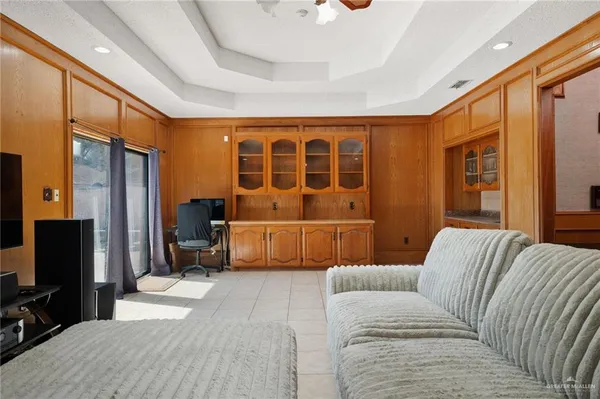 a bedroom with furniture and a flat screen tv