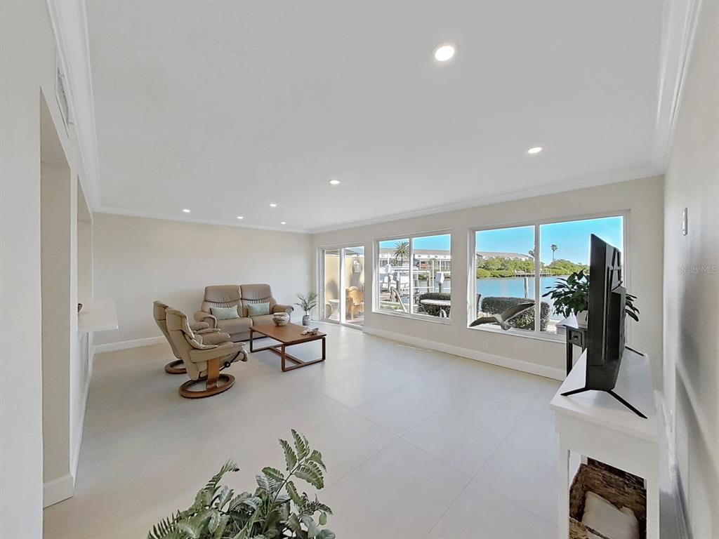 825 East Gulf Boulevard, Unit 110 Indian Rocks Beach, FL 33785 - Photo 17 of 75 a living room with furniture gym equipment and a large window