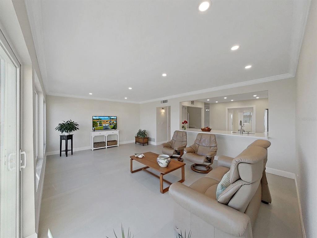 825 East Gulf Boulevard, Unit 110 Indian Rocks Beach, FL 33785 - Photo 18 of 75 a living room with furniture and large window