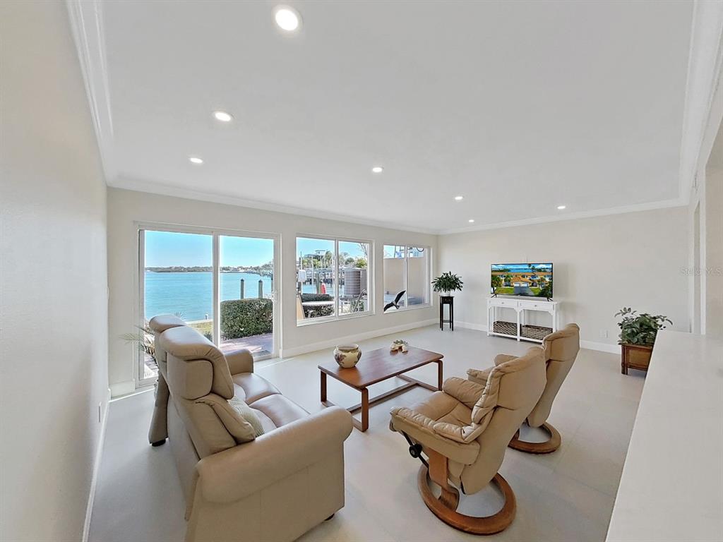 825 East Gulf Boulevard, Unit 110 Indian Rocks Beach, FL 33785 - Photo 20 of 75 a living room with furniture floor to ceiling window and floor to ceiling window