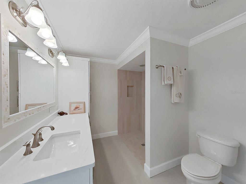 825 East Gulf Boulevard, Unit 110 Indian Rocks Beach, FL 33785 - Photo 25 of 75 a bathroom with a sink a toilet and shower