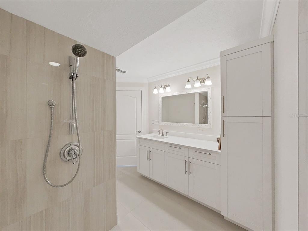 825 East Gulf Boulevard, Unit 110 Indian Rocks Beach, FL 33785 - Photo 26 of 75 a bathroom with a double vanity sink mirror and double