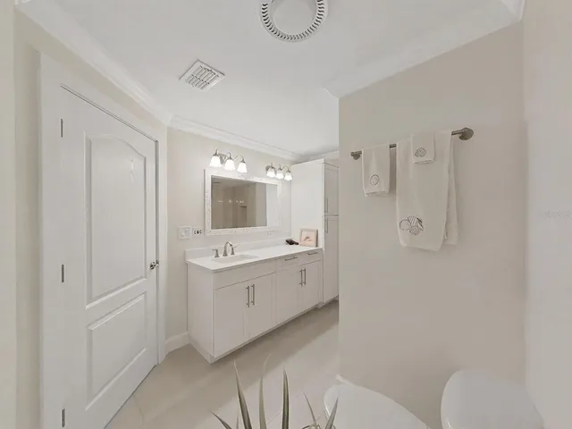 a spacious bathroom with a granite countertop sink mirror and toilet