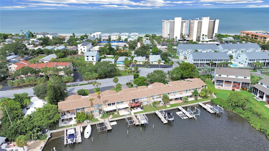 825 East Gulf Boulevard, Unit 110 Indian Rocks Beach, FL 33785 - Photo 3 of 75 a view of a patio with table and chairs and potted plants