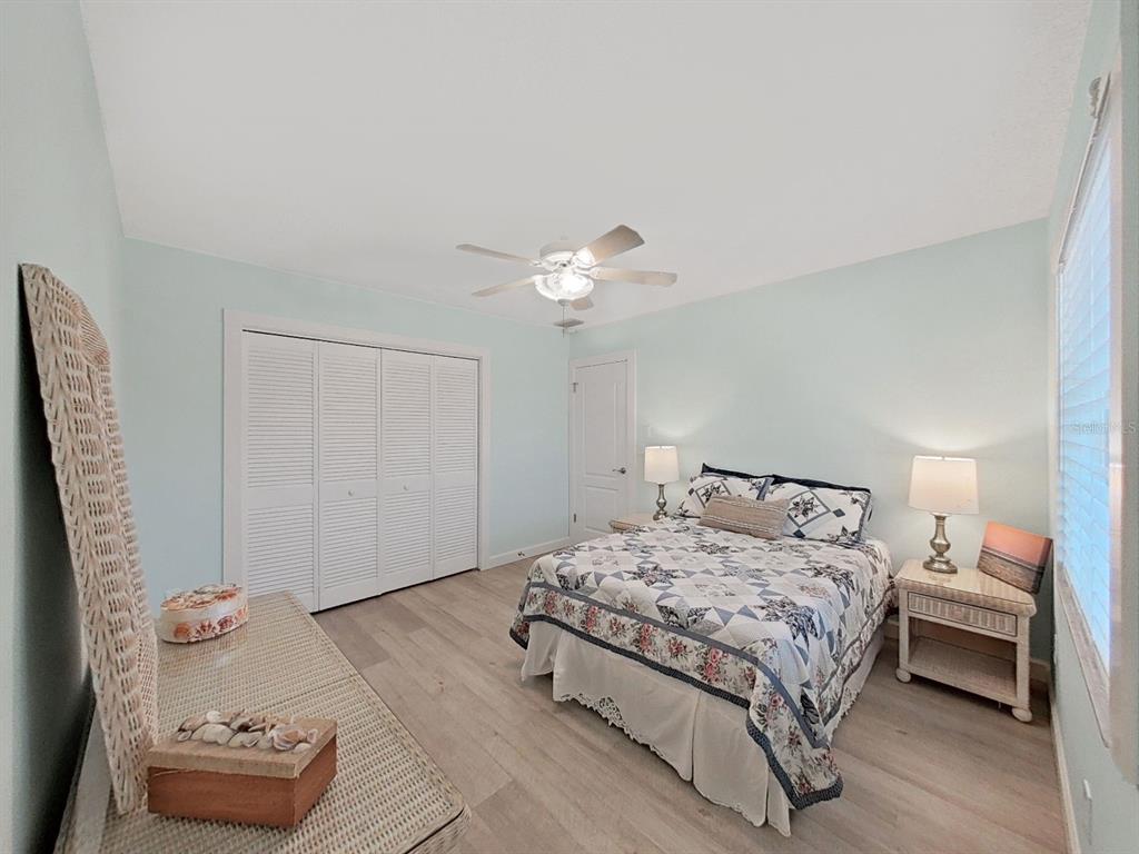 825 East Gulf Boulevard, Unit 110 Indian Rocks Beach, FL 33785 - Photo 36 of 75 a bedroom with a bed and a chandelier