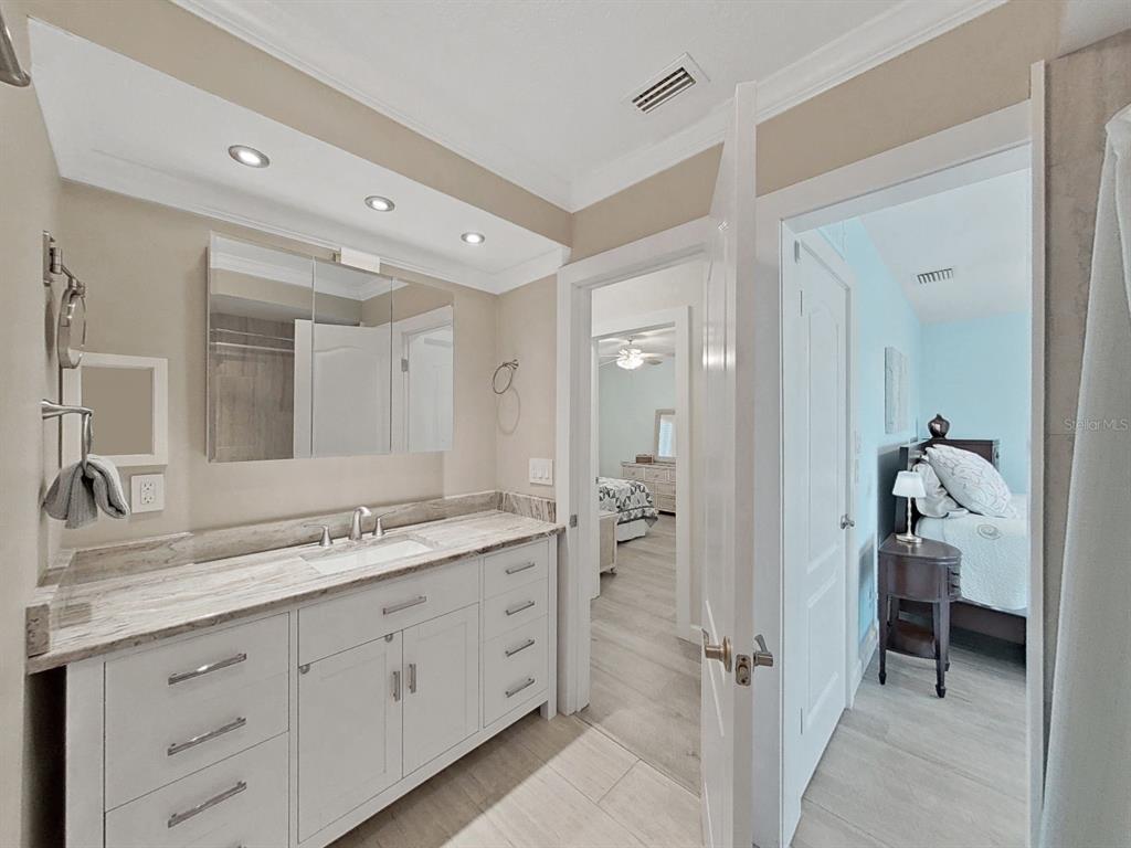 825 East Gulf Boulevard, Unit 110 Indian Rocks Beach, FL 33785 - Photo 38 of 75 a spacious bathroom with a granite countertop sink mirror and toilet