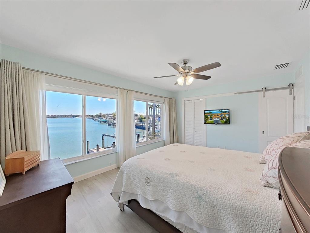 825 East Gulf Boulevard, Unit 110 Indian Rocks Beach, FL 33785 - Photo 42 of 75 a bedroom with a large bed and a large window