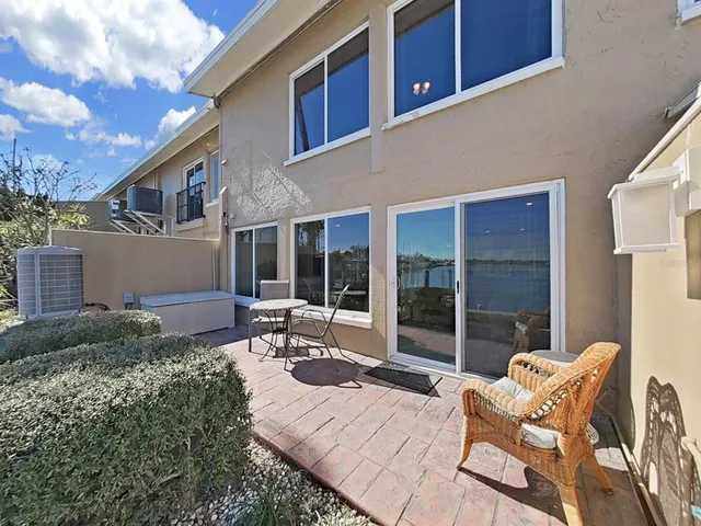 a view of a swimming pool with a patio and a yard