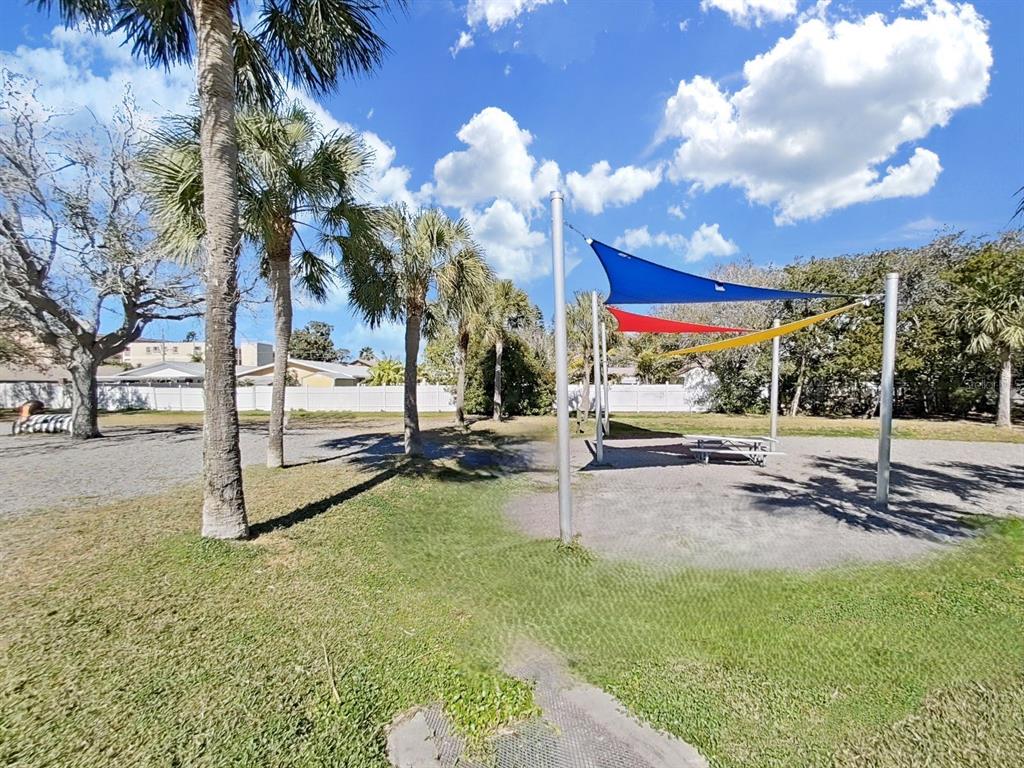 825 East Gulf Boulevard, Unit 110 Indian Rocks Beach, FL 33785 - Photo 59 of 75 a view of a park with swings and slides