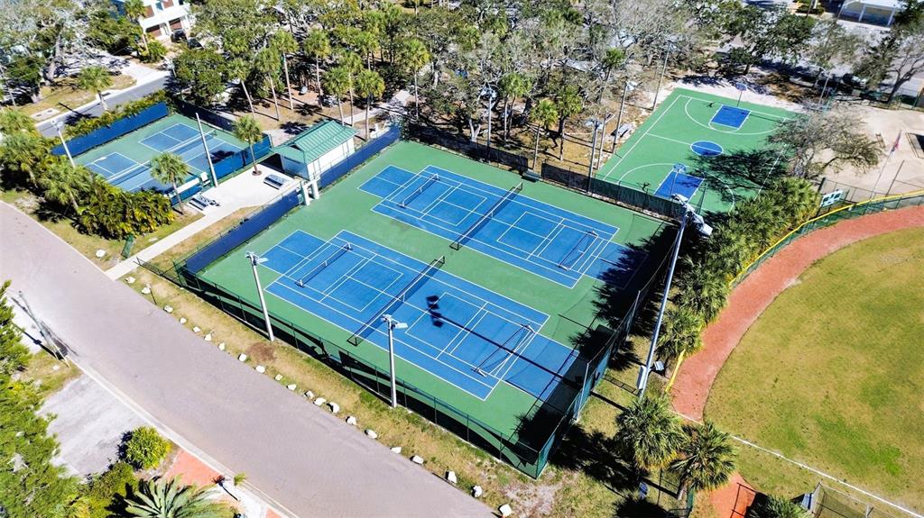 825 East Gulf Boulevard, Unit 110 Indian Rocks Beach, FL 33785 - Photo 65 of 75 an aerial view of a tennis ground and a cars park side of the road