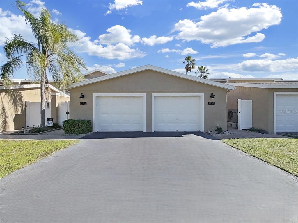 825 East Gulf Boulevard, Unit 110 Indian Rocks Beach, FL 33785 - Photo 8 of 75 front view of a house with a street