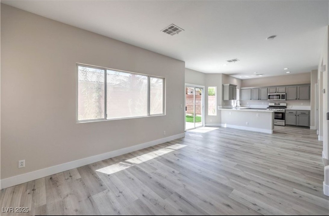 979 Park Bridge Avenue Las Vegas, NV 89123 - Photo 12 of 57 Unfurnished living room with baseboards and light wood finished floors