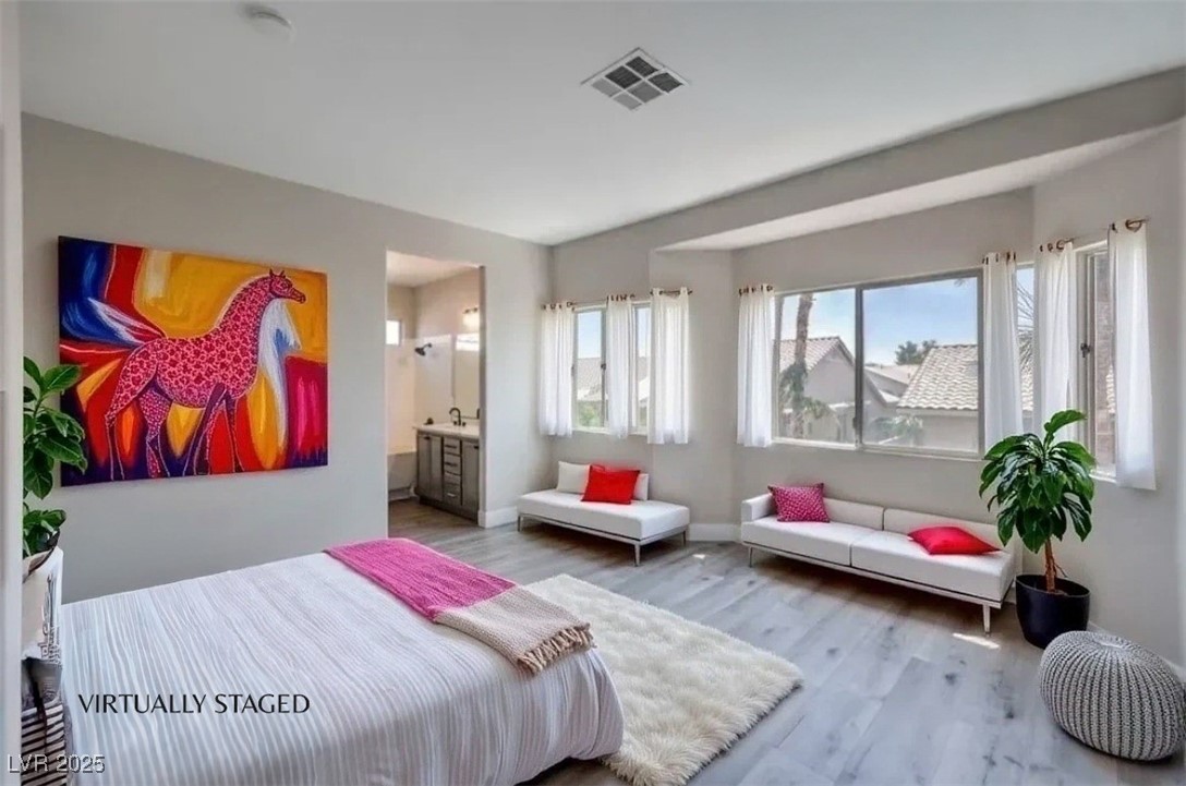 979 Park Bridge Avenue Las Vegas, NV 89123 - Photo 23 of 57 Bedroom with wood finished floors and ensuite bath