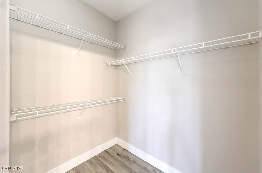 979 Park Bridge Avenue Las Vegas, NV 89123 - Photo 27 of 57 Spacious closet with light wood-style floors