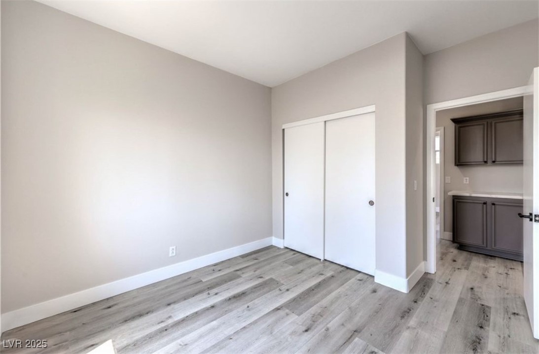 979 Park Bridge Avenue Las Vegas, NV 89123 - Photo 33 of 57 Unfurnished bedroom featuring a closet and light wood finished floors