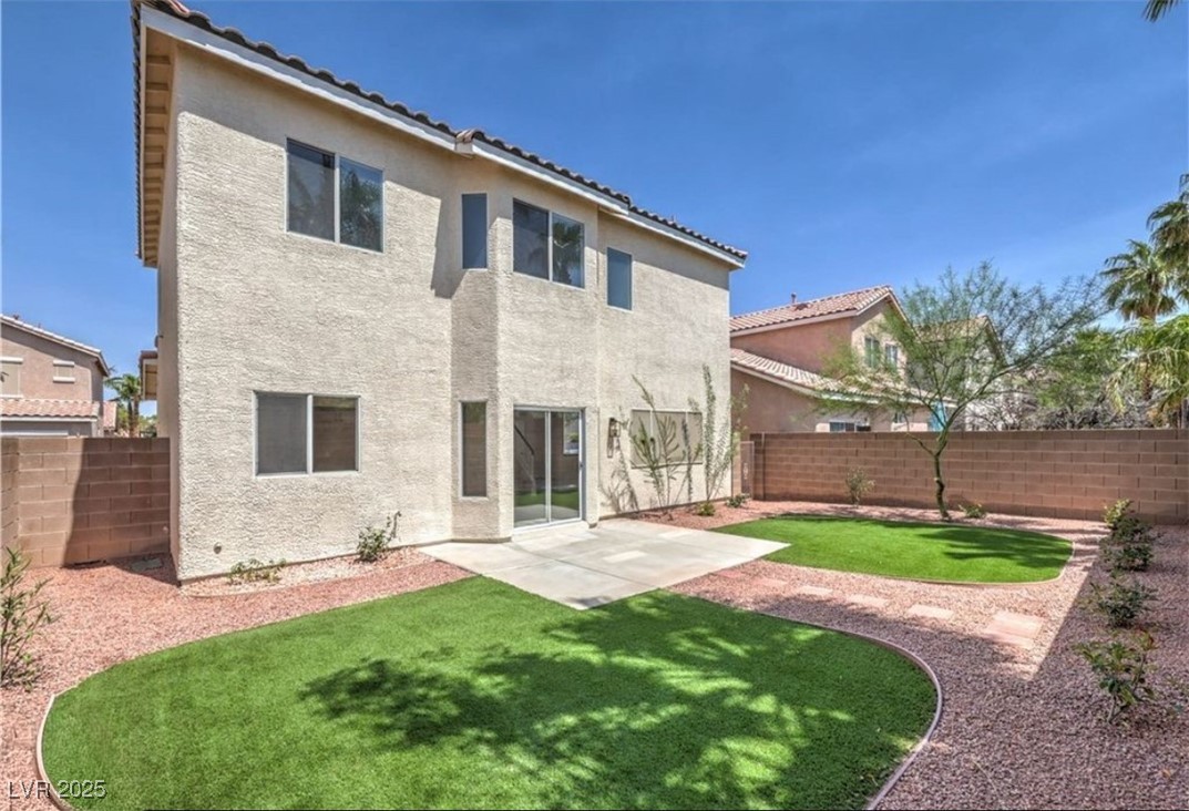 979 Park Bridge Avenue Las Vegas, NV 89123 - Photo 36 of 57 Back of property with a fenced backyard, a patio area, stucco siding, and a tile roof